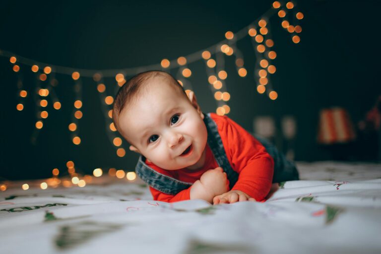 happy little boy crawling on sheet